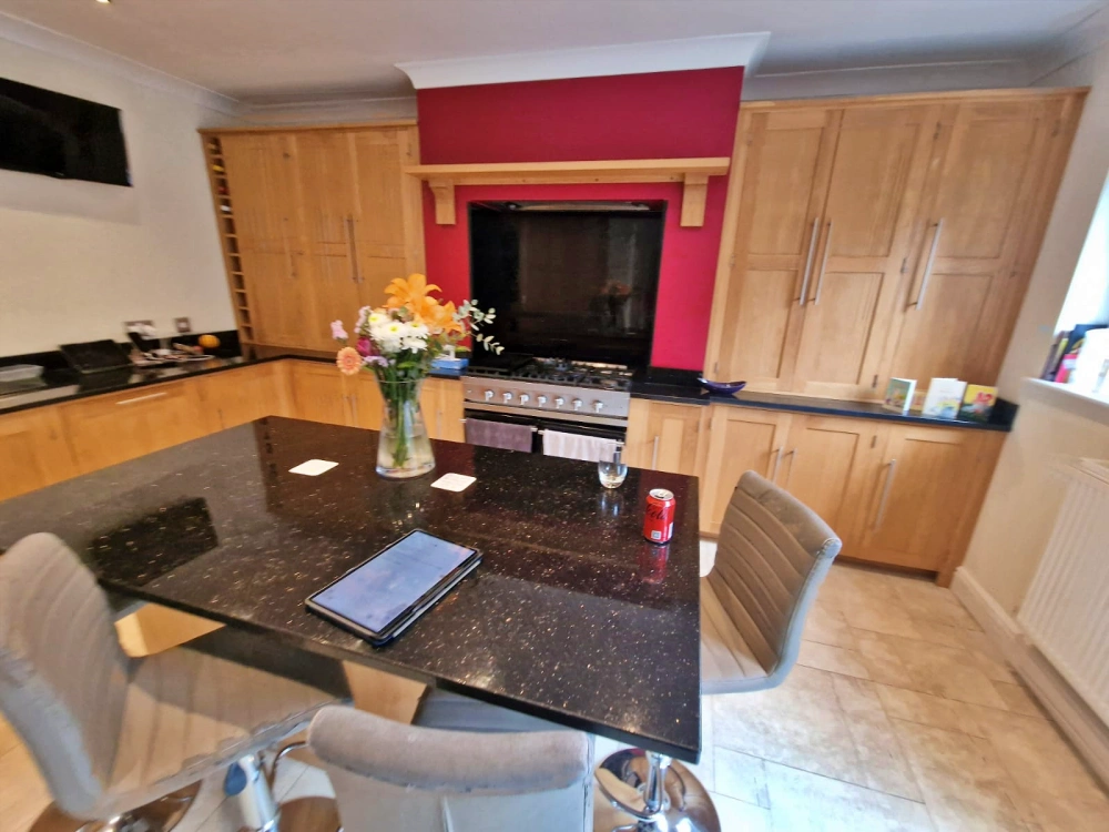 a modern kitchen island featuring an induction hob with integrated extractor. The appliance needed to be installed in the island, which immediately raised a technical challenge